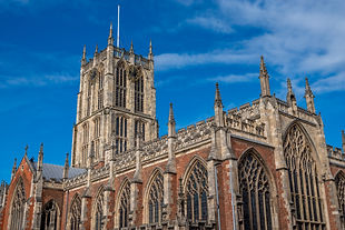 Hull Minster church tower with clock with a blue sky background on a sunny day..jpg