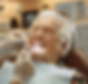 elderly-woman-is-smiling-while-her-teeth-are-being-taken-care-her.jpg
