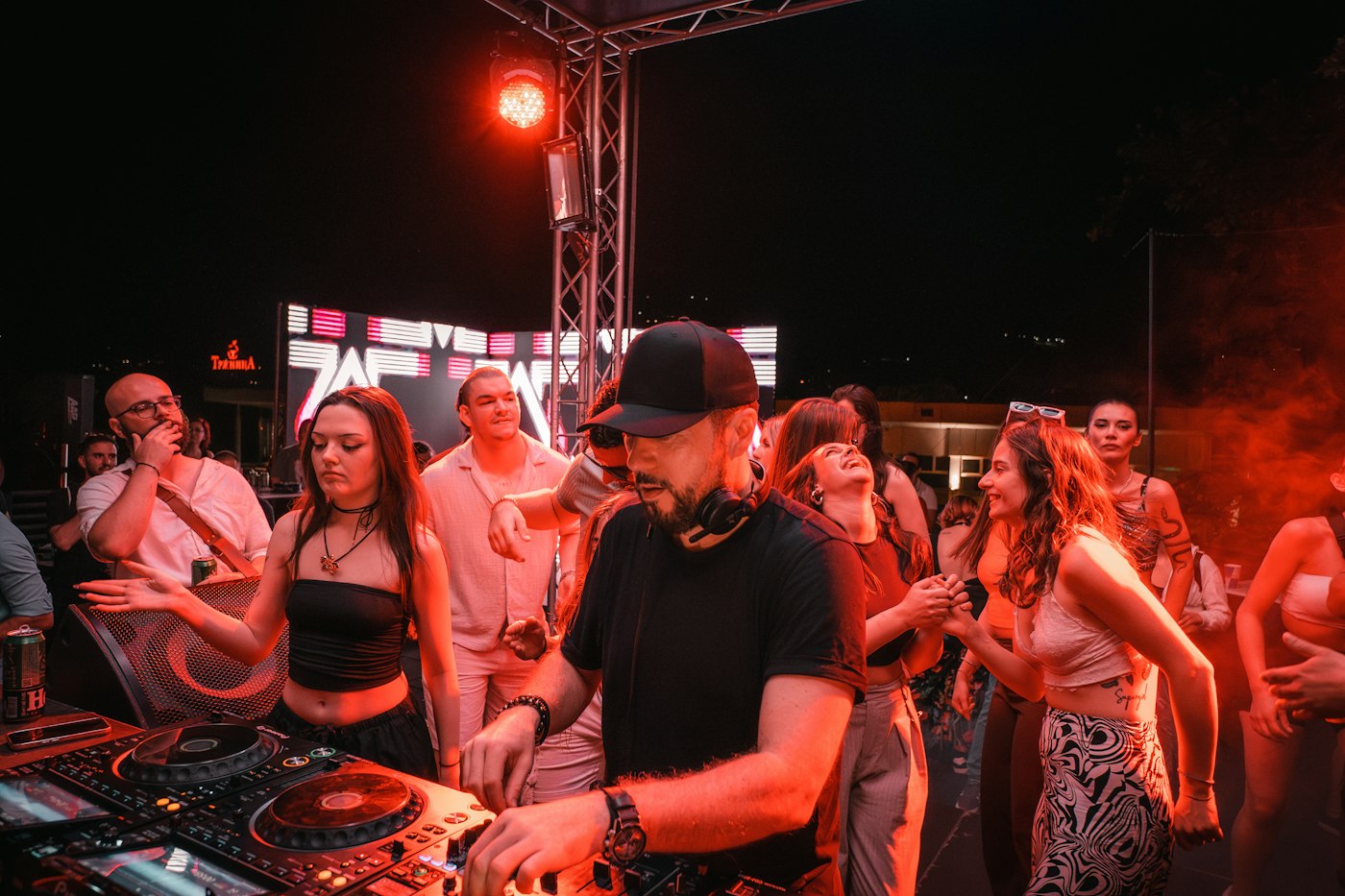 Real editorial photograph of dj performing at a night festival. Cover for Safer Sound at Outdoor Festivals