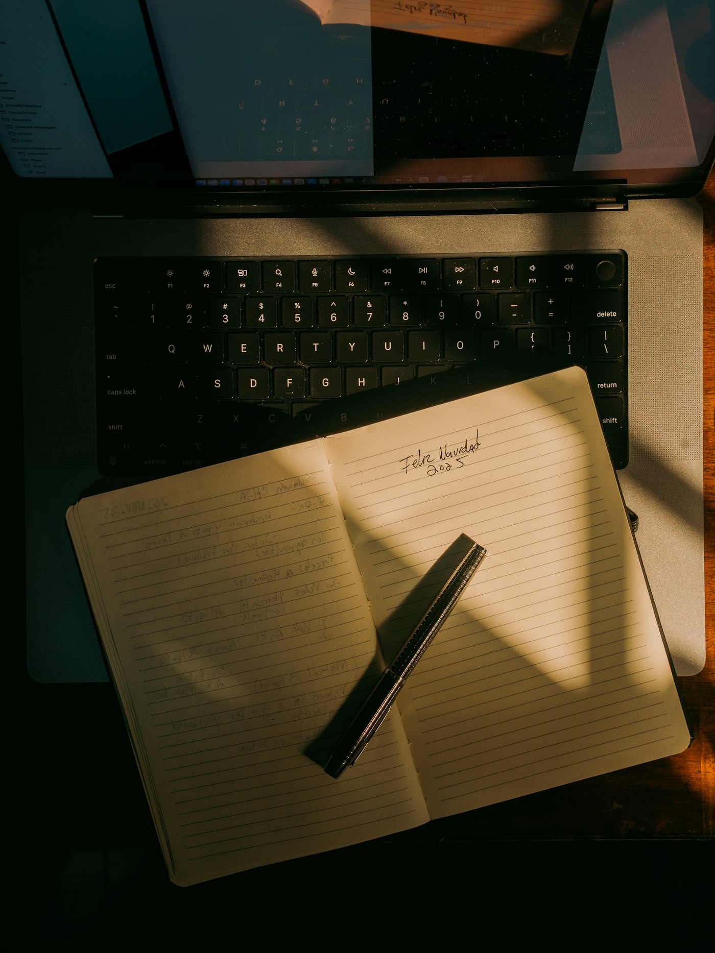 Real editorial photograph of open notebook and pen on laptop. Cover for Turning Online Connections Into Real Friendships