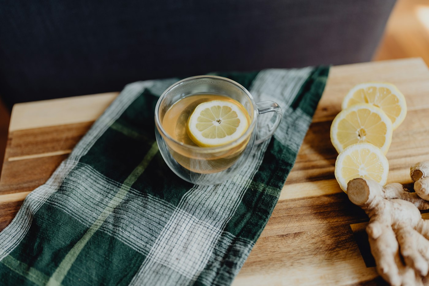 Real editorial photograph of herbal tea with lemons and ginger. Cover for Tea Meditation: Make One Ordinary Cup an Experience
