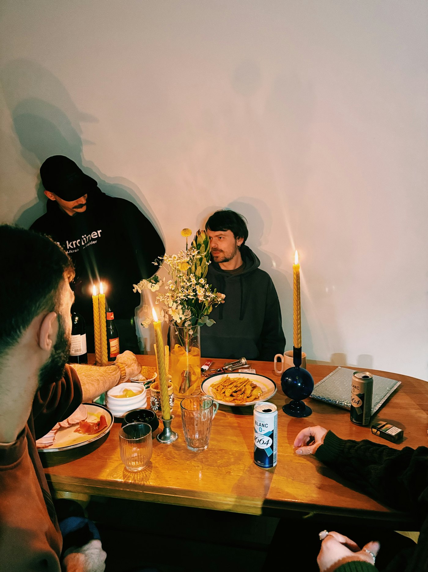 Real editorial photograph of shared community meal and candles. Cover for How Volunteers Avoid Burning Out