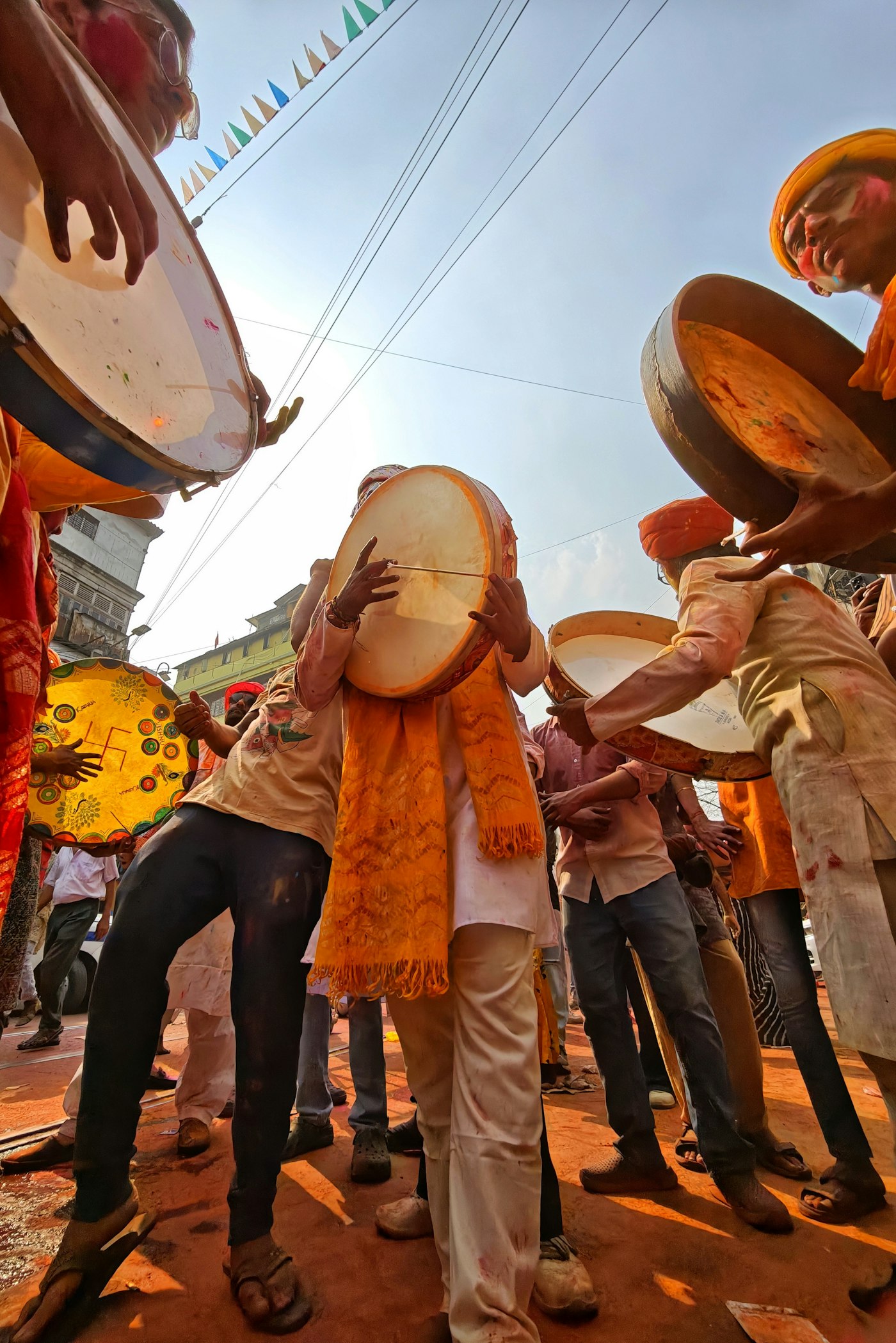 Real editorial photograph of drummers at holi festival. Cover for A Drumming Circle for Kids and Adults: One Rhythm, Many Abilities