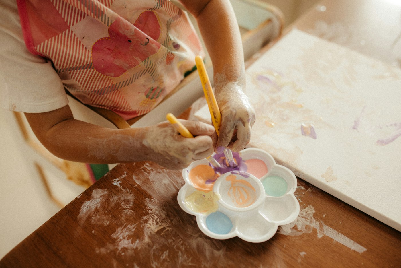Real editorial photograph of child painting on a canvas. Cover for A Five-Minute Sketchbook for Busy People