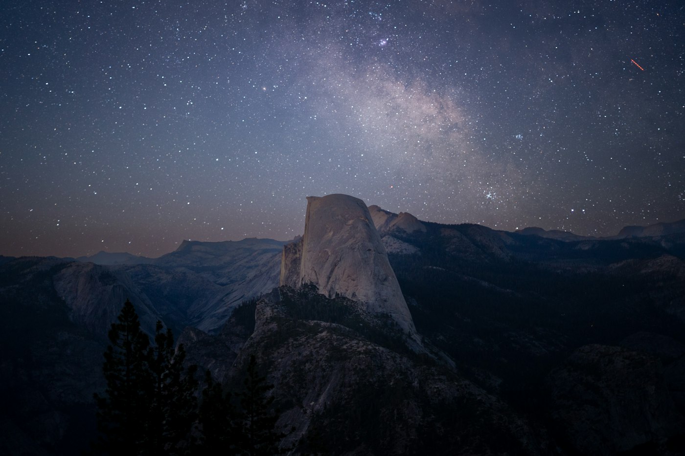 Real editorial photograph of stars over mountain. Cover for Reading the Night Sky Without an App