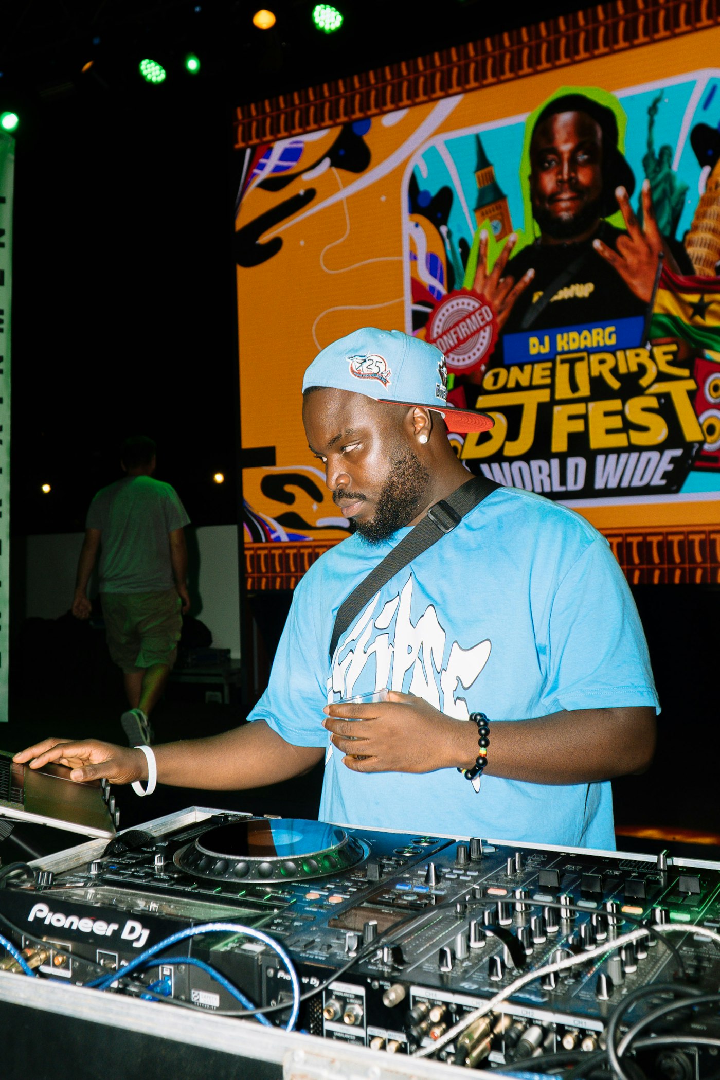 Real editorial photograph of dj performing with mixer. Cover for Frame Drum Basics: How to Make a Small Drum Sound Huge