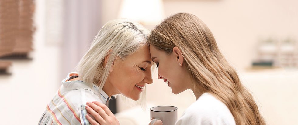 Mother and daughter embracing by touching foreheads