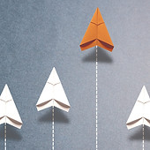 An image of a paper airplane soaring ahe