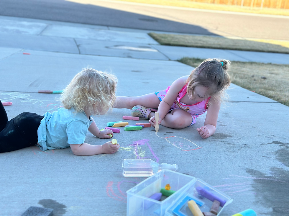 Two girls playing with chalk