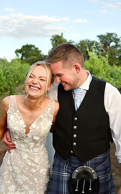 bride and groom laughing in a still from their wedding video