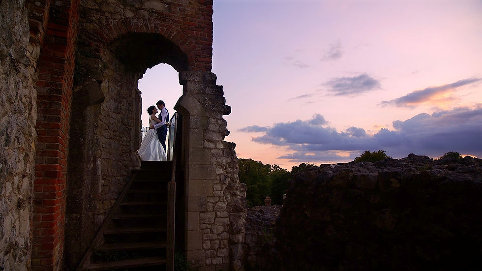 Bride and groom kissing at sunset in the keep at Farnham Castle