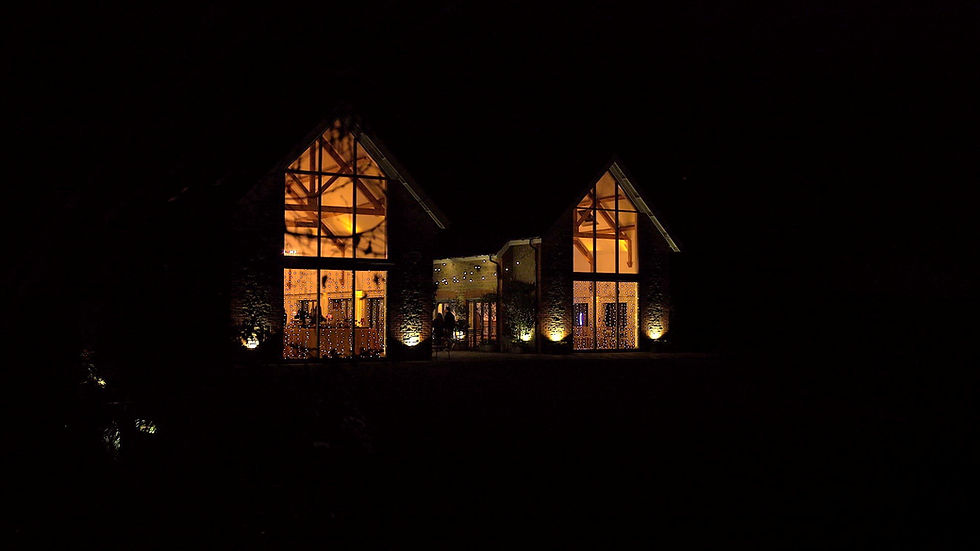 The barns at Millbridge Court wedding venue lit up at night