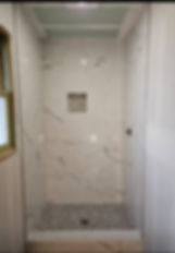 Modern residential remodeling of a marble walk-in shower.