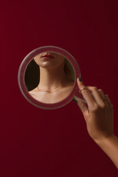 A woman looking at herself in the mirror to see who she really is