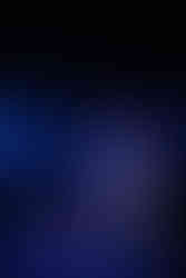 Three contemporary dancers mid-performance under purple/blue lighting, expressive and theatrical