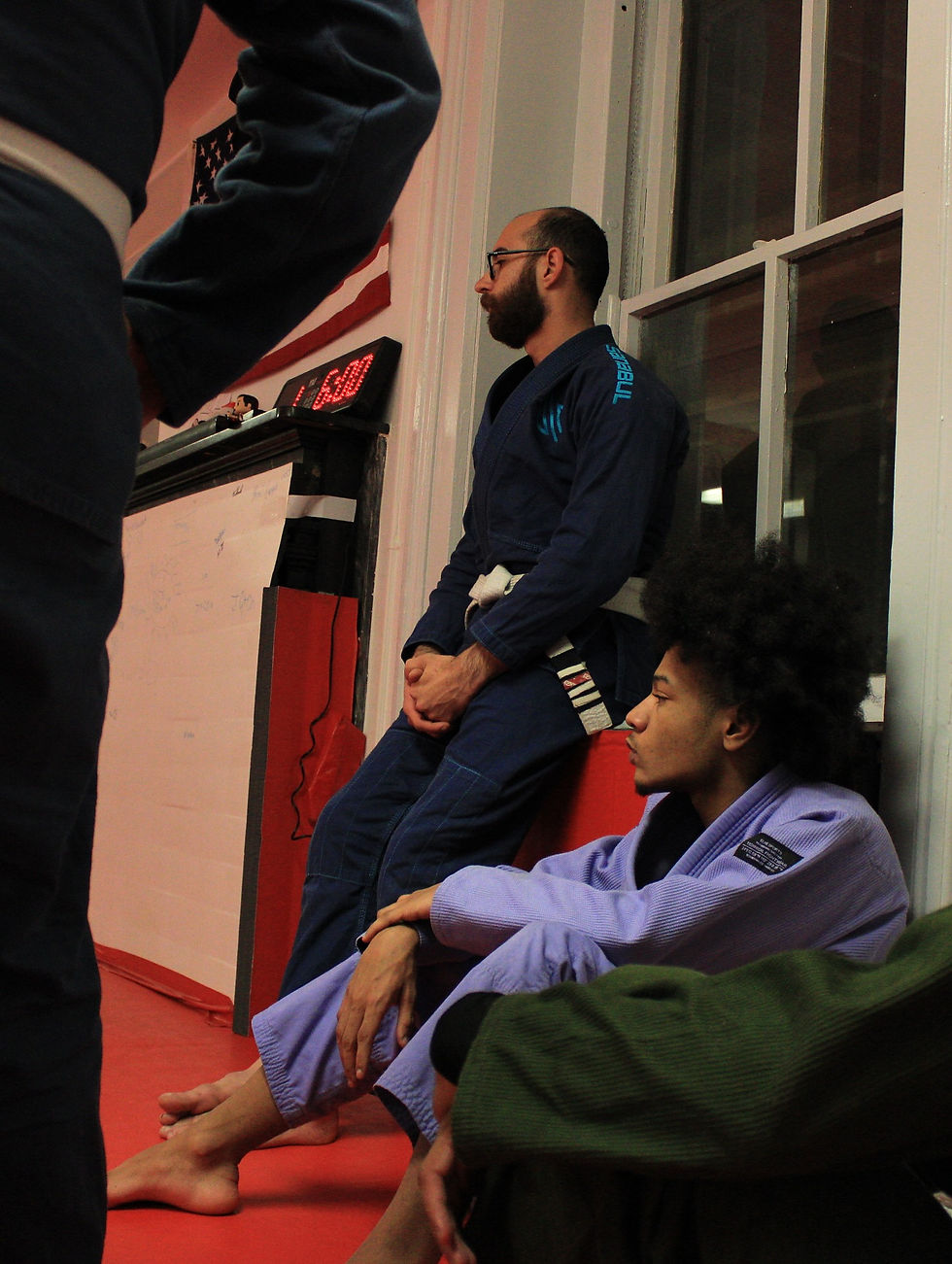 Close-up view of a Brazilian Jiu Jitsu gi and belt on a training mat