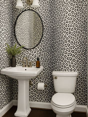 Custom leopard print wallpaper installed by Mill End Shops in a modern powder room