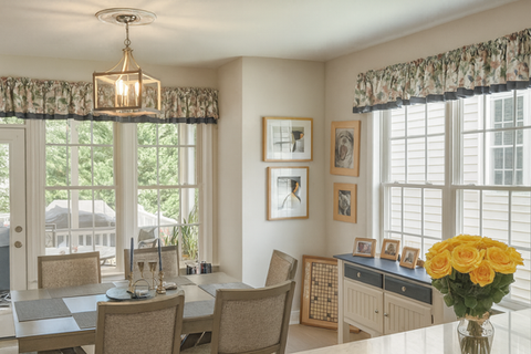 Custom shirred valance on a rod with solid petticoat layered window treatment in dining room by Mill End Shops