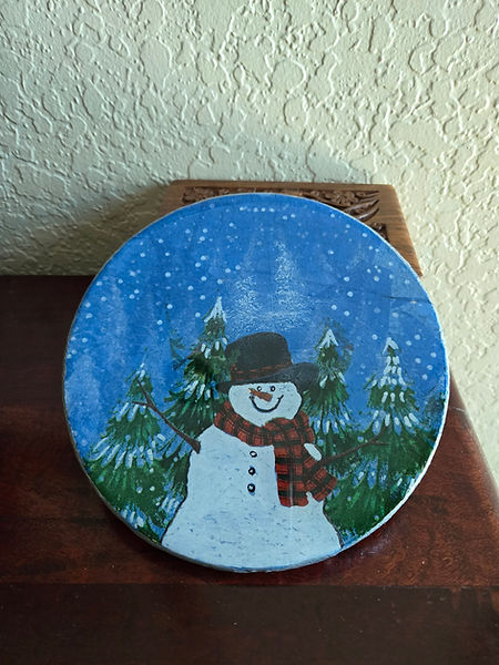 Snowman Hot Pad | 8" round cork hot pad painted in white and silver with a napkin decoupaged of a snowman in the forest | snowman | snowman decor | decoupage | decoupage art | decoupage craft | Christmas decor | winter wonderland | resin | resin crafts