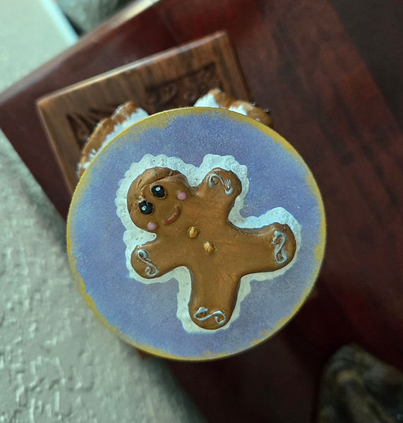 Gingerbread Man Candle | 6" candle decorated with five air dry clay gingerbread men surrounding the candle and on the lid in purples and gold | candles | gingerbread man | acrylic painting | air dry clay creations