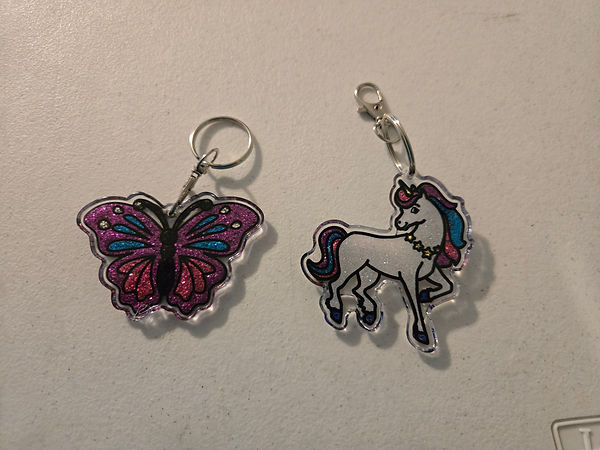 Butterflies and Unicorns | 1.5" butterfly and unicorn key chains with glitter varnish and finished in UV resin | resin | UV resin crafts | butterflies | unicorns | key chains | key chains for sale