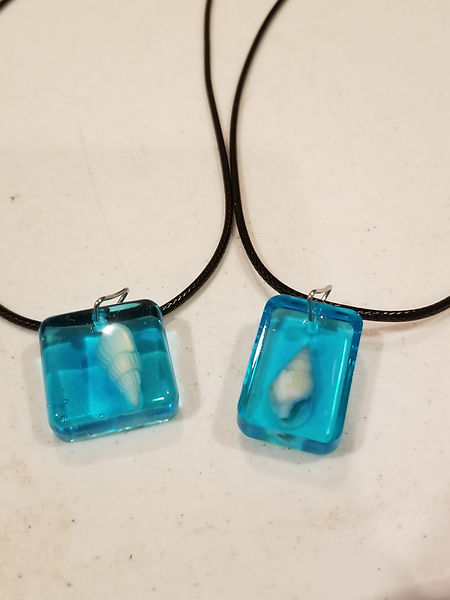 Resin Jewelry | 1" resin jewelry in sea blue with white sea shells embedded with 18" wax cord | resin | resin jewelry | resin art | resin craft | resin artist | resin craft| sea shells | seashell jewelry