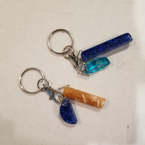 Resin key chains in blues and blue and gold with sparkles and glitter| resin | resin art | resin craft | resin artist | resin crafter | resin key chains for sale