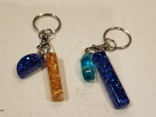 Resin key chains in blues and blue and gold with sparkles and glitter| resin | resin art | resin craft | resin artist | resin crafter | resin key chains for sale