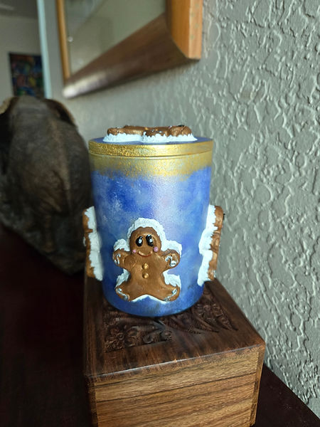 Gingerbread Man Candle | 6" candle decorated with five air dry clay gingerbread men surrounding the candle and on the lid in purples and gold | candles | gingerbread man | acrylic painting | air dry clay creations