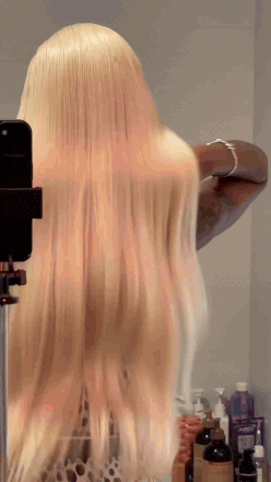 Model wearing blonde 613 straight wig, HD 13x6 lace front, 250% density raw human hair, sleek bone-straight finish