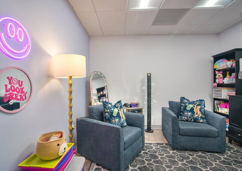Therapy room with armchair and warm lighting at Katz Psychological Services.