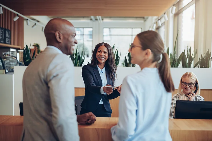 Guests being welcomed by friendly smiling staff