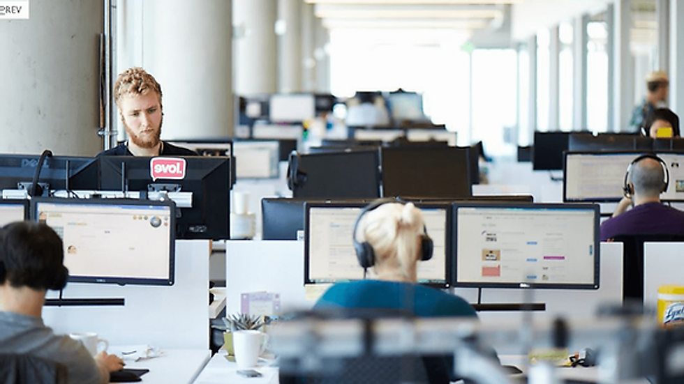 Employees working at computers in modern office