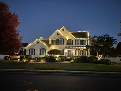 Christmas lights on two story home, lights on gable, lights on ridge
