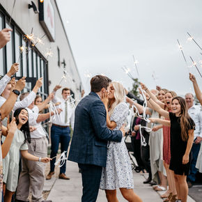 Couple kissing during thier wedding sparkler exit