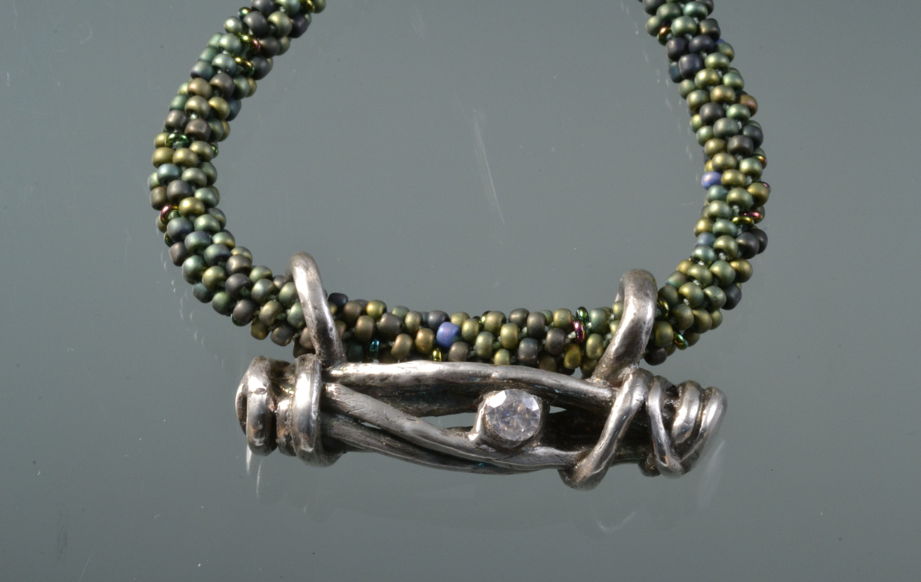 Silver clay branches broach on green/teal beaded kumihimo necklace