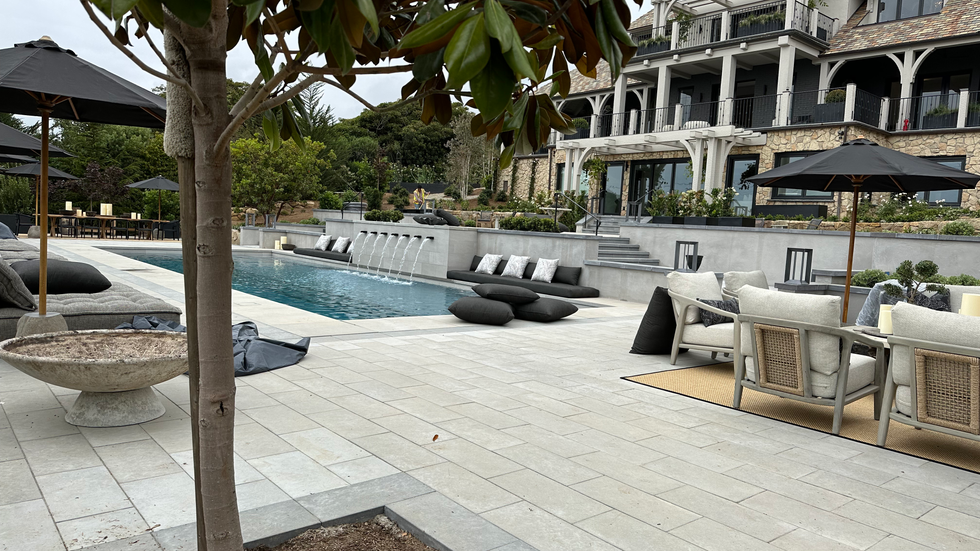 a large house with a swimming pool in front of it