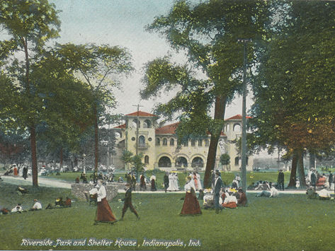 Postcard image of the Riverside Park shelter house with visitors milling around outside of the shelter.