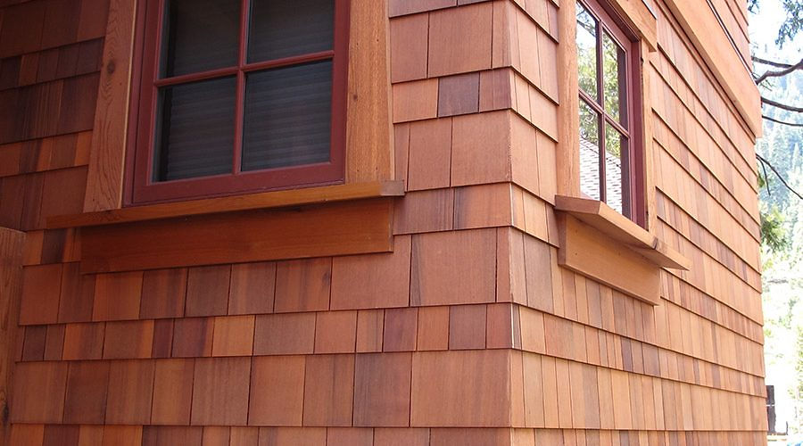 Cedar shingle siding, red windows, Rhode Island carpentry