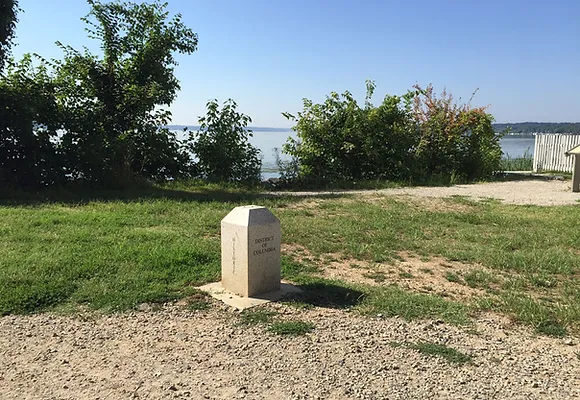 A cornerstone marking the original boundary of the District of Columbia is shown standing in a grassy field in Jones Point Park in Alexandria.