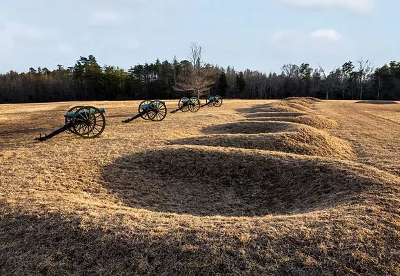 Cannon emplacements line the top of a grassy hill at Hazel Grove