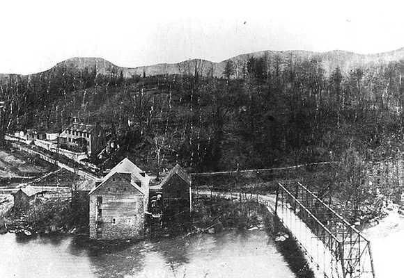 A historical newspaper photo showing the destruction of the Route 1 bridge following Hurricane Agnes.