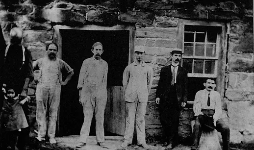The last millwrights standing in front of the Merchants Mill in Occoquan.
