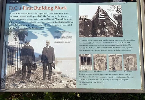 A historical information marker that speaks about the first cornerstone erected at Jones Point to mark the border of the District of Columbia.