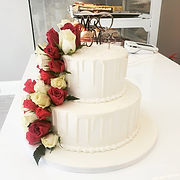 white wedding cake with red roses