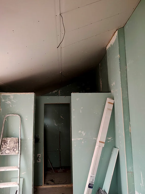 room with plaster boards and a step ladder