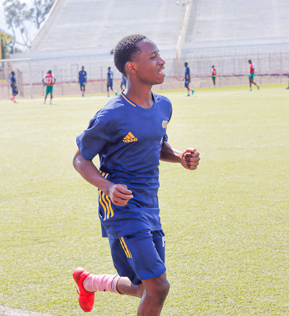Innocent Chapalapata prepares to join the action on the football field, exuding energy and focus