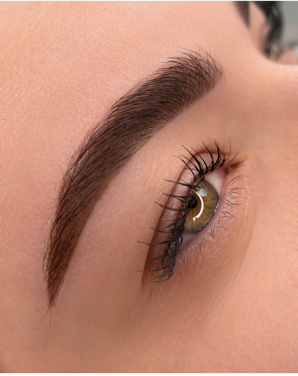 Client's eyebrow after powder brows treatment, natural makeup-like shading