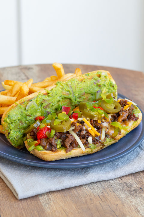 open-faced beef sandwich on a plate with fries