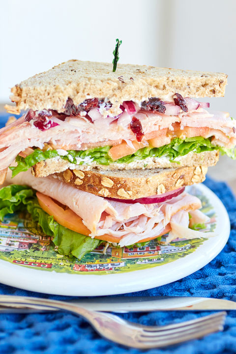 a turkey sandwich cut in half on a plate